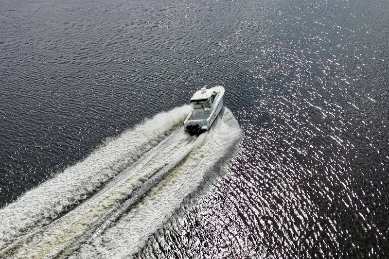 Mr Ceo Yacht Photos Pics Aerial view of 2015 Boston Whaler 315 Conquest cruising on shimmering water.