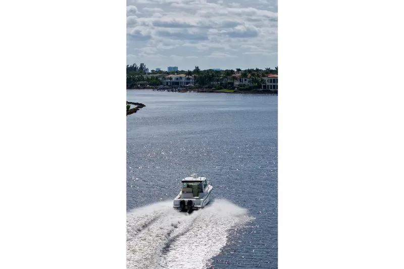 Mr Ceo Yacht Photos Pics 2015 Boston Whaler 315 Conquest cruising on a scenic waterway.