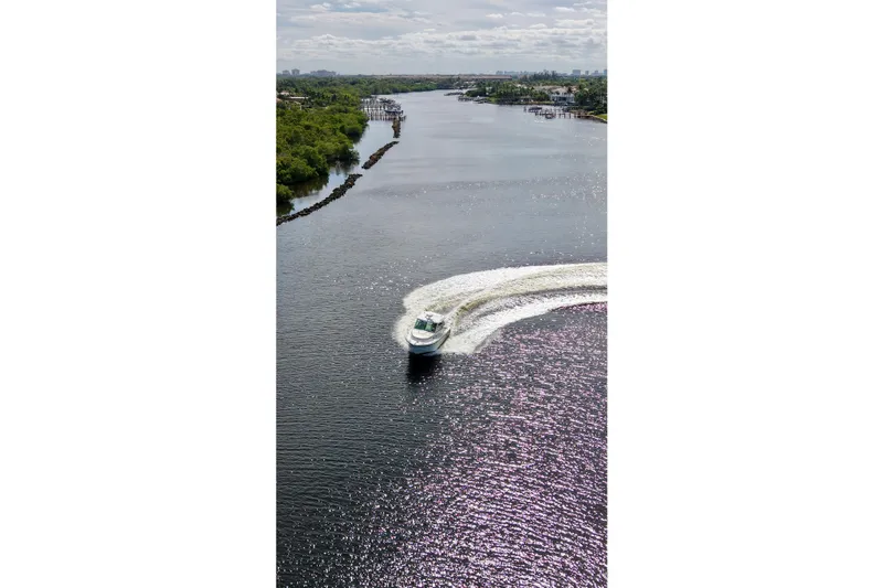 Mr Ceo Yacht Photos Pics Aerial view of 2015 Boston Whaler 315 Conquest cruising on a scenic river.