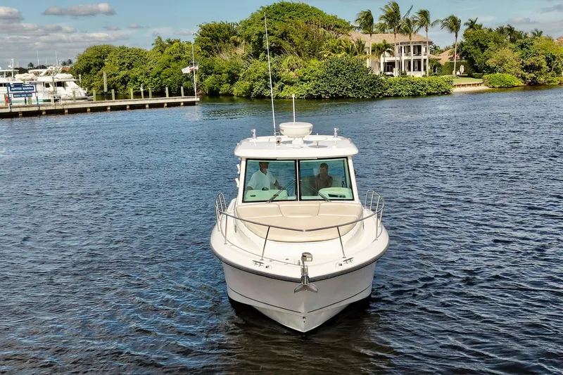 Mr Ceo Yacht Photos Pics 2015 Boston Whaler 315 Conquest boat cruising on a scenic waterway.
