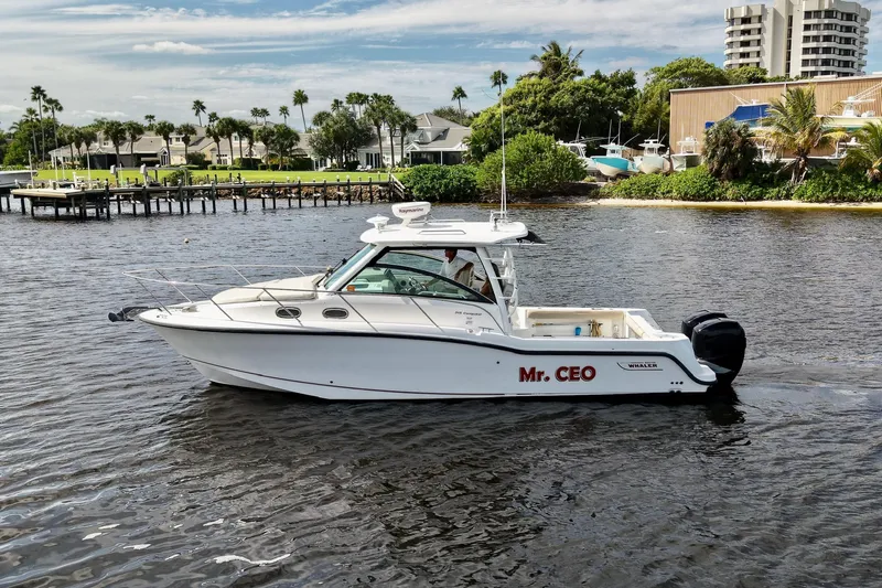 Mr Ceo Yacht Photos Pics 2015 Boston Whaler 315 Conquest boat named "Mr. CEO" on a scenic waterway.
