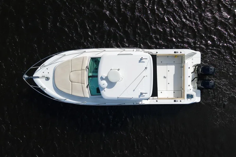 Mr Ceo Yacht Photos Pics Overhead view of 2015 Boston Whaler 315 Conquest boat on dark water.