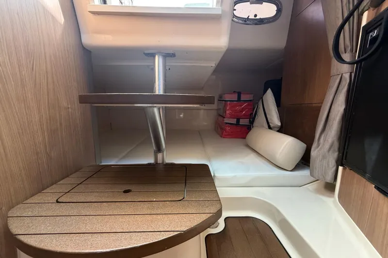 Mr Ceo Yacht Photos Pics Interior cabin of 2015 Boston Whaler 315 Conquest with wooden table and seating.