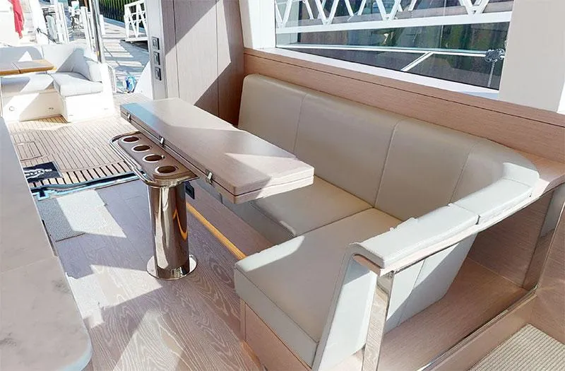 Yacht Photos Pics Luxurious seating area on 2022 Sunseeker Manhattan 68 yacht with sleek table design.