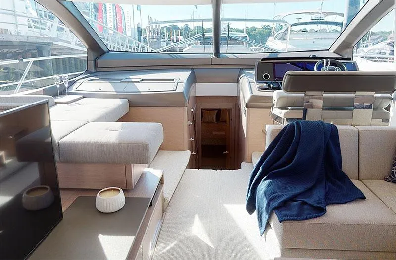  Yacht Photos Pics Luxurious interior of 2022 Sunseeker Manhattan 68 yacht with modern furnishings and panoramic windows.