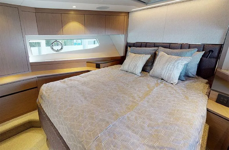 Yacht Photos Pics Luxurious bedroom interior of 2022 Sunseeker Manhattan 68 yacht with elegant bedding and wood finishes.