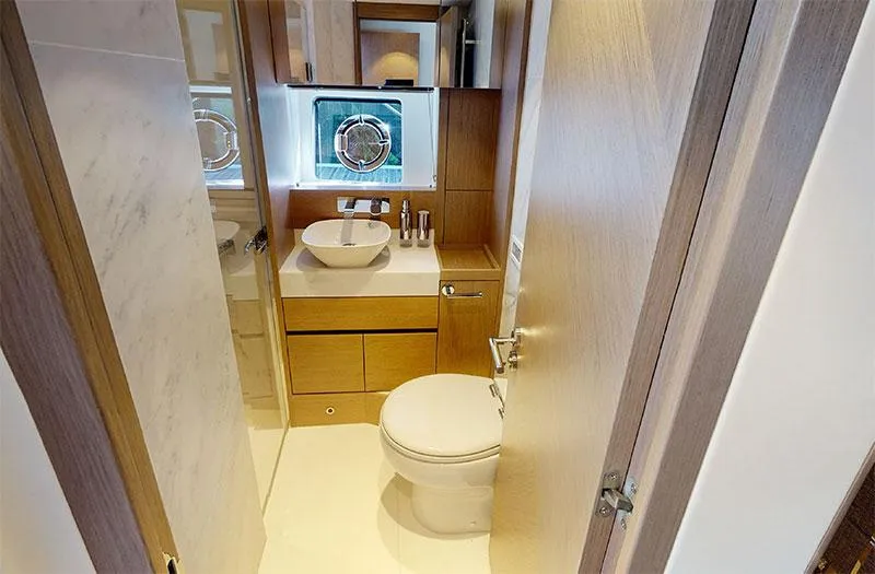  Yacht Photos Pics Luxurious bathroom in 2022 Sunseeker Manhattan 68 yacht with modern fixtures and elegant design.