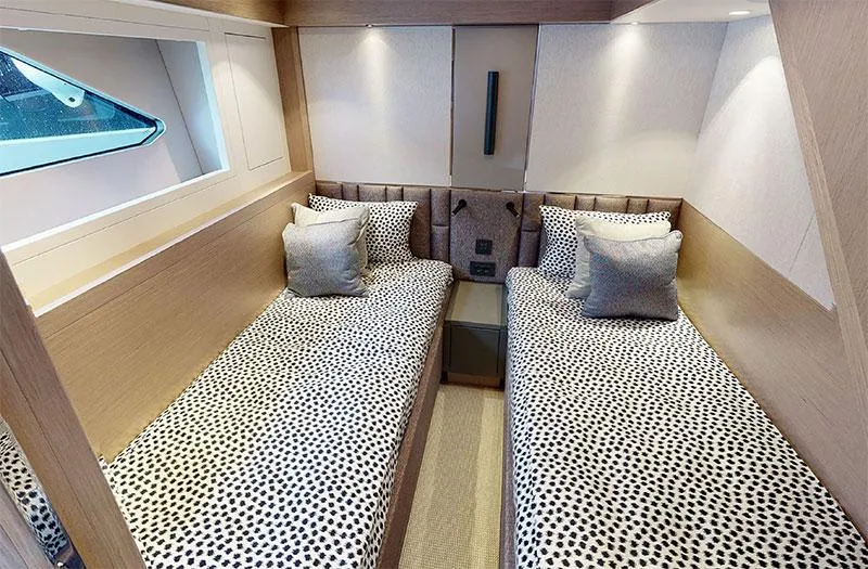  Yacht Photos Pics Luxurious twin cabin in 2022 Sunseeker Manhattan 68 yacht, featuring modern decor and cozy bedding.