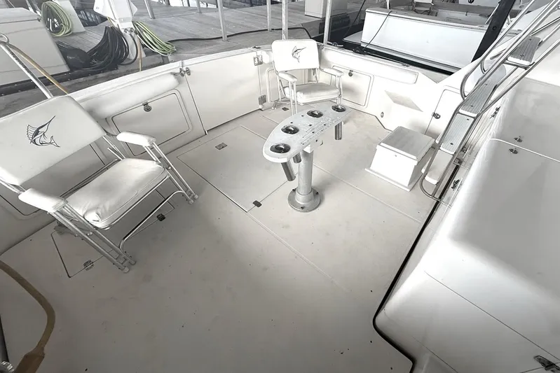  Yacht Photos Pics 1996 Riviera 39 Open Flybridge boat deck with chairs and fishing rod holders.