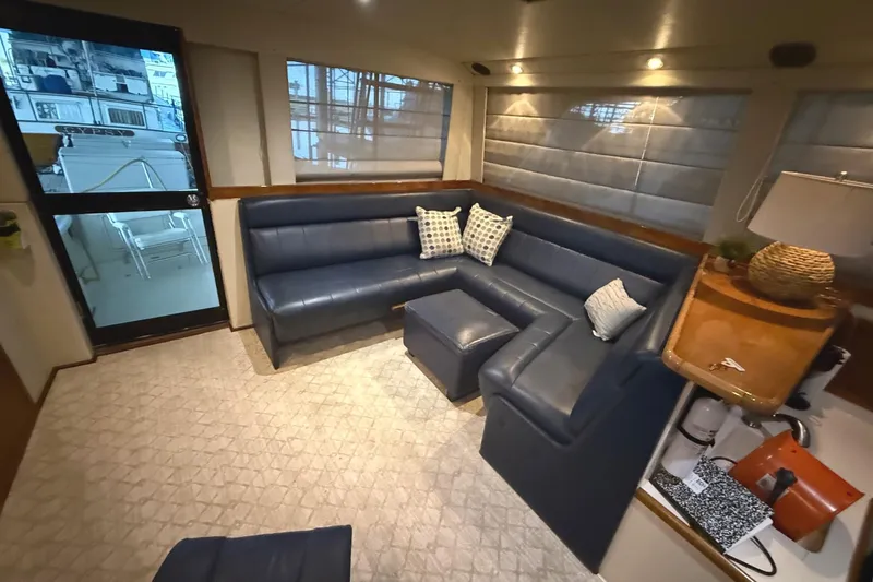  Yacht Photos Pics Interior of 1996 Riviera 39 Open Flybridge with blue leather seating and modern decor.