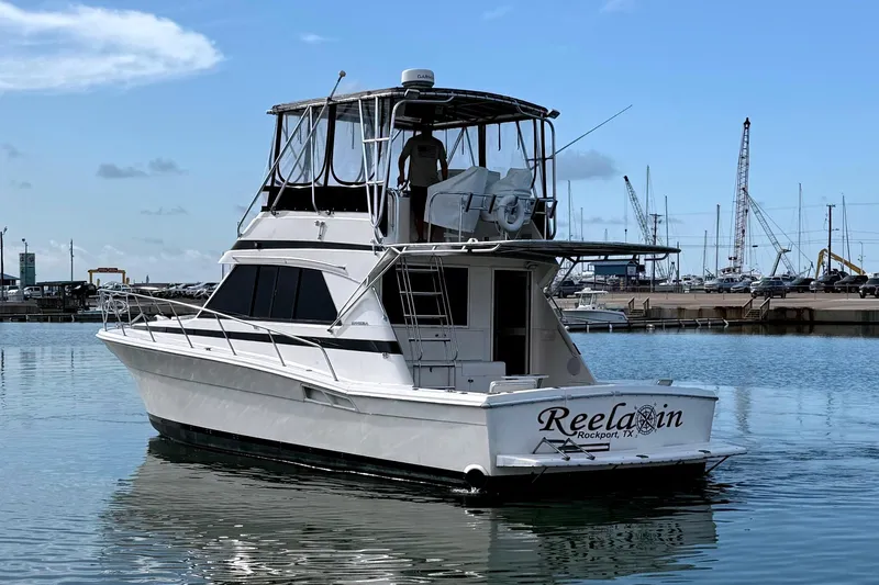  Yacht Photos Pics 1996 Riviera 39 Open Flybridge yacht docked in a marina, clear sky background.