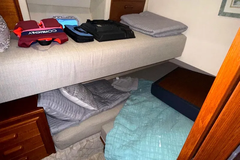  Yacht Photos Pics Interior cabin of 1996 Riviera 39 Open Flybridge with bunk beds and storage.