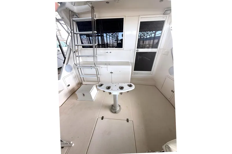  Yacht Photos Pics 1996 Riviera 39 Open Flybridge boat interior with ladder and fishing station.