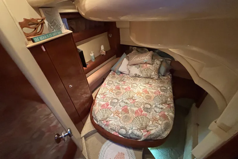  Yacht Photos Pics Cozy cabin interior of 2007 Meridian 391 Sedan with floral bedding and wooden cabinetry.