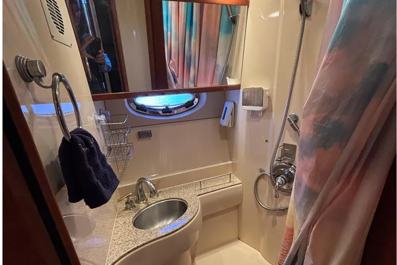  Yacht Photos Pics 2007 Meridian 391 Sedan bathroom with sink, shower, and porthole window.