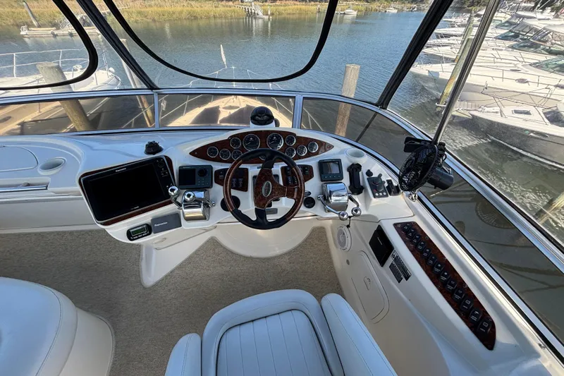  Yacht Photos Pics 2007 Meridian 391 Sedan helm with steering wheel, controls, and navigation equipment.