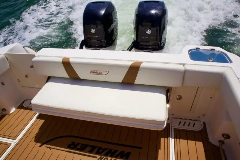  Yacht Photos Pics 2013 Boston Whaler 320 Outrage boat with twin Mercury engines and cushioned seating.