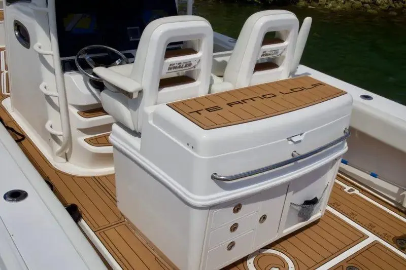  Yacht Photos Pics 2013 Boston Whaler 320 Outrage boat interior with dual seats and teak flooring.