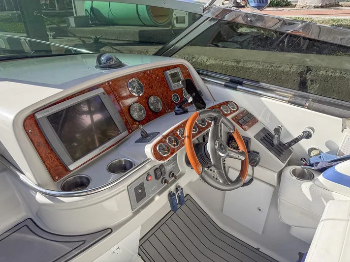 Gentleman's Legacy Yacht Photos Pics 2004 Formula 400 Super Sport boat cockpit with wood accents and modern controls.