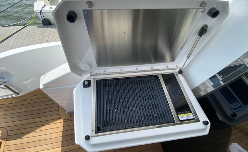 Radiant Yacht Photos Pics Outdoor grill on 2022 Cruisers Yachts 60 Fly, featuring sleek design and modern amenities.