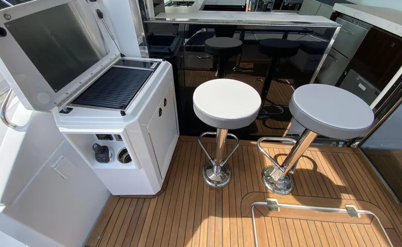 Radiant Yacht Photos Pics Luxurious 2022 Cruisers Yachts 60 Fly deck with bar stools and grill.