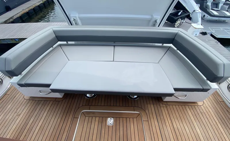 Radiant Yacht Photos Pics Luxurious seating area on 2022 Cruisers Yachts 60 Fly, featuring sleek design and wooden deck.