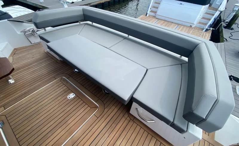Radiant Yacht Photos Pics Luxurious seating on 2022 Cruisers Yachts 60 Fly, featuring sleek design and teak flooring.