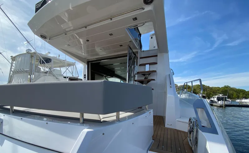 Radiant Yacht Photos Pics 2022 Cruisers Yachts 60 Fly, luxury yacht exterior with stairs and seating area.