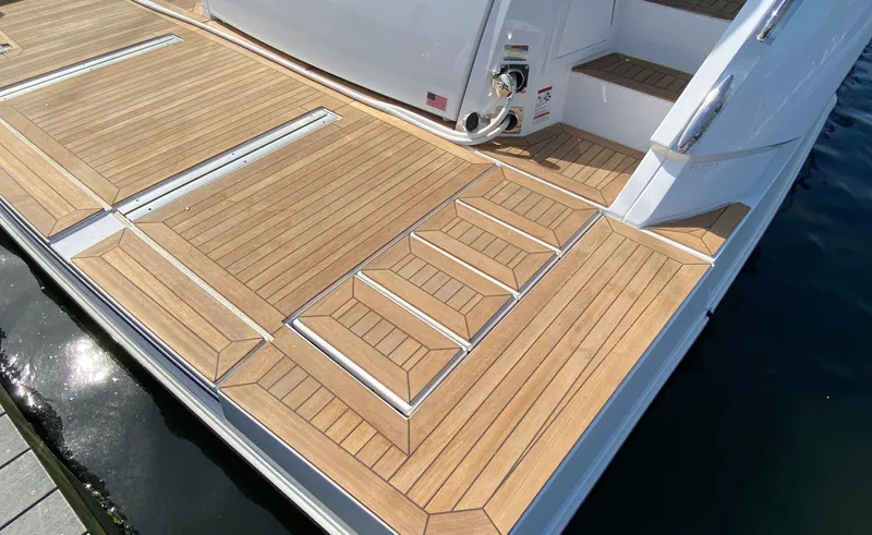 Radiant Yacht Photos Pics Luxury teak deck of 2022 Cruisers Yachts 60 Fly, featuring elegant steps.