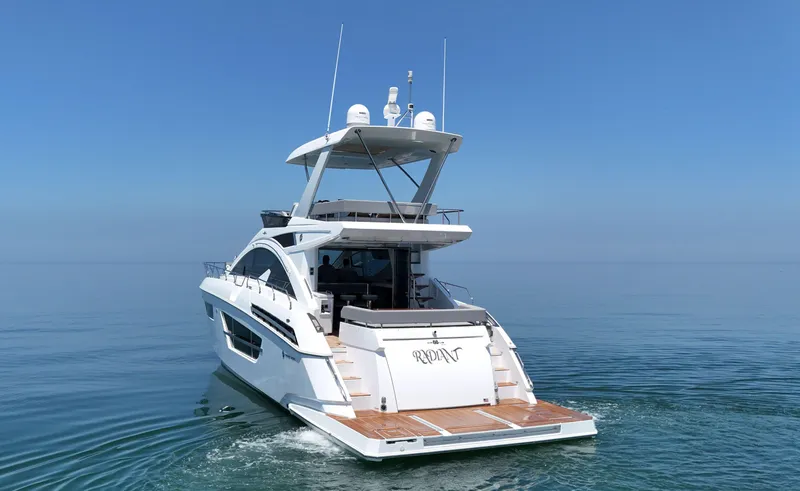 Radiant Yacht Photos Pics 2022 Cruisers Yachts 60 Fly on calm sea, rear view.