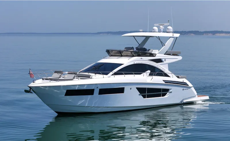 Radiant Yacht Photos Pics 2022 Cruisers Yachts 60 Fly luxury yacht cruising on calm blue waters.