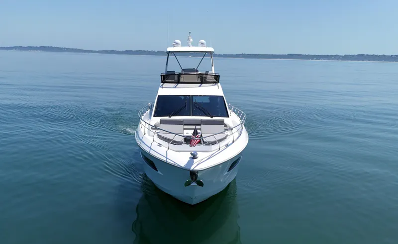 Radiant Yacht Photos Pics 2022 Cruisers Yachts 60 Fly on calm water, front view.