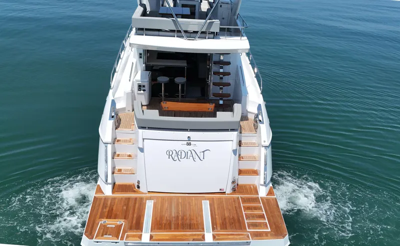 Radiant Yacht Photos Pics 2022 Cruisers Yachts 60 Fly on water, showcasing elegant design and spacious deck.