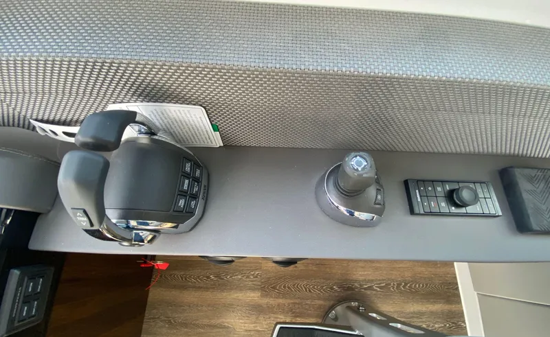 Radiant Yacht Photos Pics Control panel of 2022 Cruisers Yachts 60 Fly, featuring joystick and throttle controls.