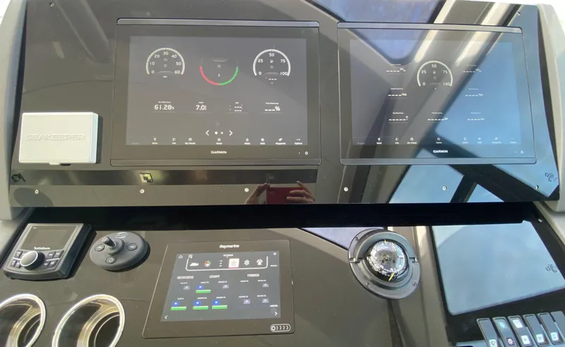 Radiant Yacht Photos Pics Control panel of 2022 Cruisers Yachts 60 Fly with digital displays and navigation instruments.