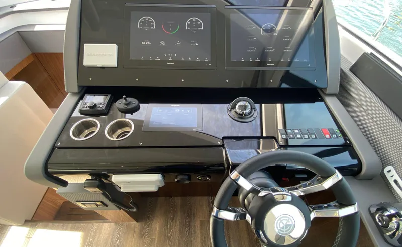 Radiant Yacht Photos Pics Helm of 2022 Cruisers Yachts 60 Fly, featuring modern controls and navigation displays.