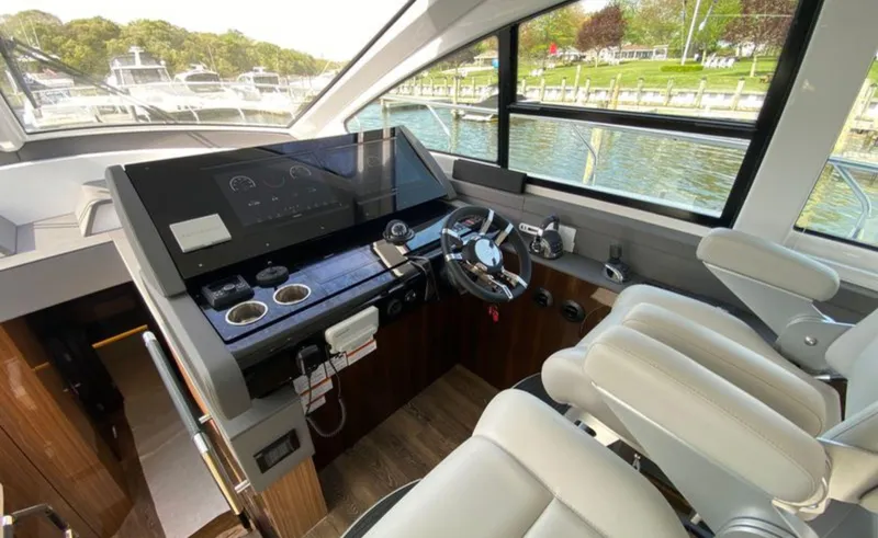 Radiant Yacht Photos Pics Interior helm of 2022 Cruisers Yachts 60 Fly, featuring modern controls and luxurious seating.