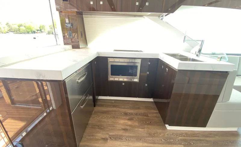 Radiant Yacht Photos Pics Luxurious kitchen interior of 2022 Cruisers Yachts 60 Fly with modern appliances and sleek design.