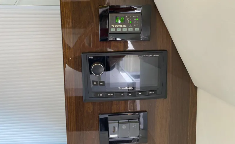 Radiant Yacht Photos Pics Control panel on 2022 Cruisers Yachts 60 Fly, featuring Dometic and Rockford Fosgate systems.