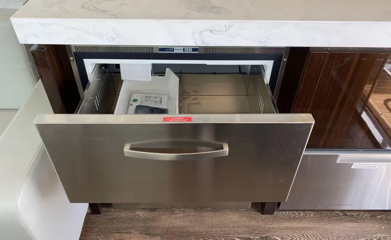 Radiant Yacht Photos Pics Open drawer refrigerator in 2022 Cruisers Yachts 60 Fly kitchen area.