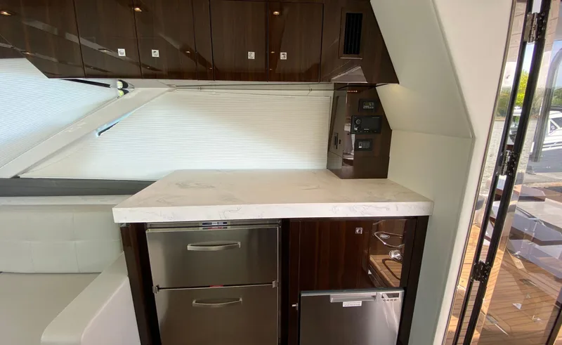 Radiant Yacht Photos Pics Luxurious kitchen area in 2022 Cruisers Yachts 60 Fly with modern appliances and sleek cabinetry.