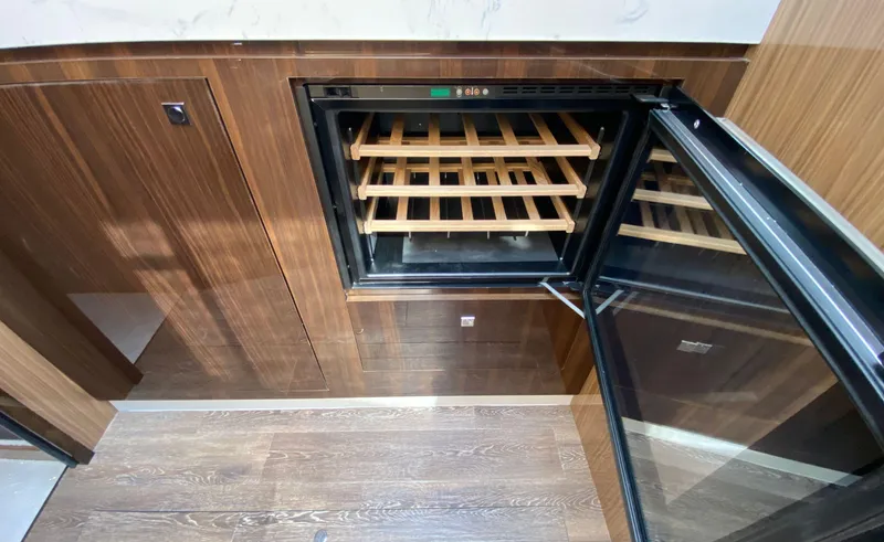 Radiant Yacht Photos Pics Luxury yacht interior with open wine cooler, wooden finish, Cruisers Yachts 60 Fly 2022 model.
