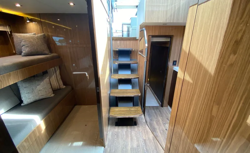 Radiant Yacht Photos Pics Interior of 2022 Cruisers Yachts 60 Fly, featuring wooden finishes and bunk beds.