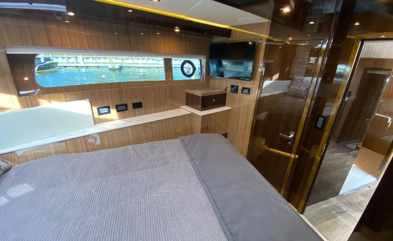 Radiant Yacht Photos Pics Luxurious interior of 2022 Cruisers Yachts 60 Fly with wood paneling and water view.