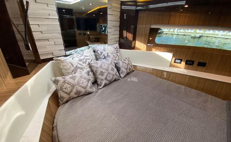 Radiant Yacht Photos Pics Luxurious bedroom interior of 2022 Cruisers Yachts 60 Fly with elegant bedding and window view.