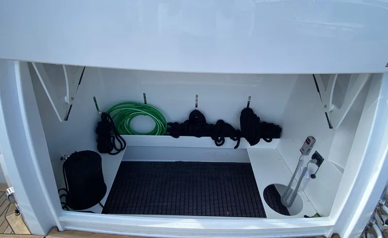 Radiant Yacht Photos Pics Storage compartment of 2022 Cruisers Yachts 60 Fly with ropes and hose.