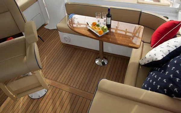 Reel Gratitude Yacht Photos Pics Luxurious interior of 2014 Release Boatworks 46 Custom Express Carolina with elegant seating and table.