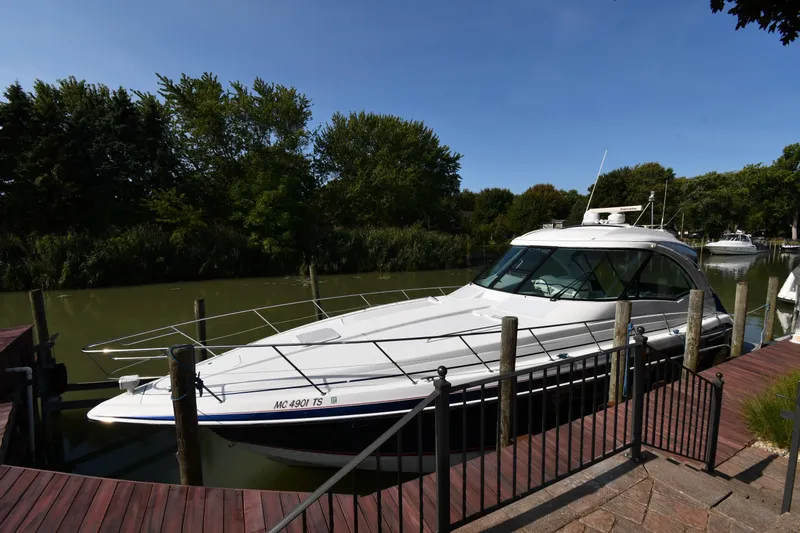  Yacht Photos Pics 2007 Formula 45 Yacht docked on a serene river with lush greenery.