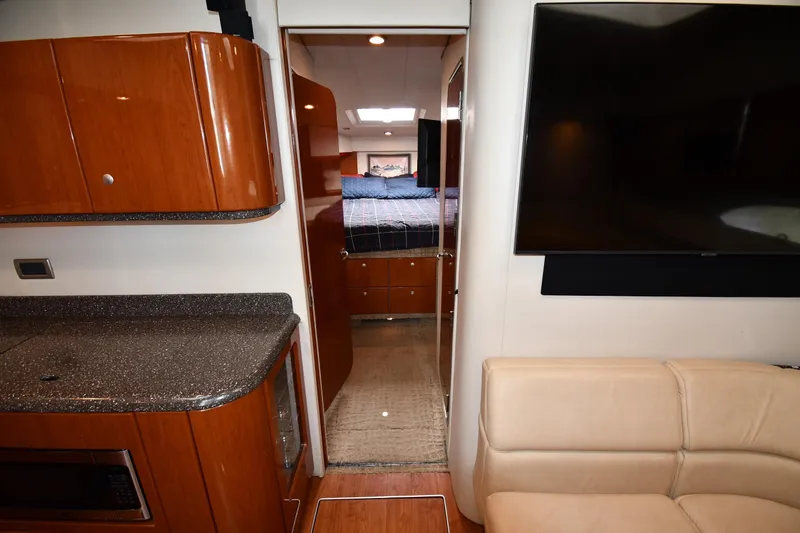  Yacht Photos Pics Interior of 2007 Formula 45 Yacht with modern kitchen and cozy bedroom.