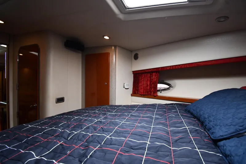  Yacht Photos Pics Interior cabin of 2007 Formula 45 Yacht with bed and porthole window.